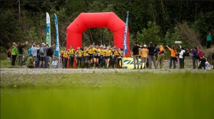 Teams set off at a run on a 7 day wilderness adventure.