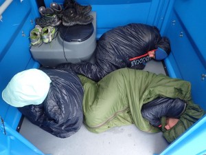Team Traces of Nuts sleeping in a port-a-loo at Expedition Alaska
